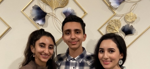 three siblings smiling for a photo
