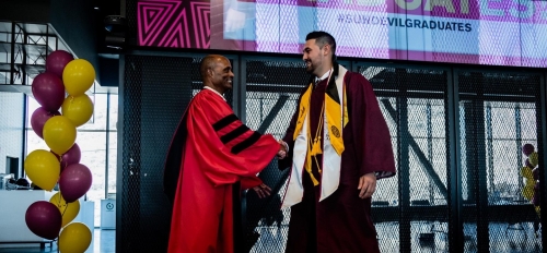 Man shaking hands with graduate