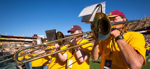 Alumni perform with the Marching Band at Homecoming