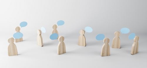 stock photo of wooden people with conversation bubbles