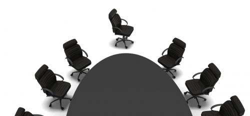 Chairs around the edge of a conference table