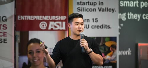 Man speaking into a microphone at an ASU entreprenership event.