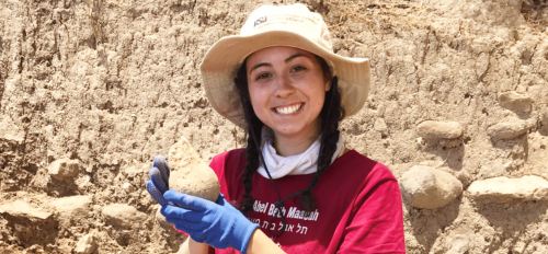Molly Corr holding a vessel from the excavation site Tel Abel Beth Maacah in Northern Israel.