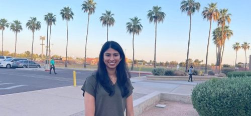 ASU College of Integrative Sciences and Arts applied biological sciences graduate Nandini Mishra outdoors with palm trees in backdrop
