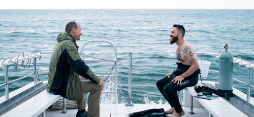 Two men on a boat in the ocean