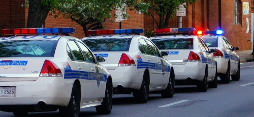 line of police cars on a street