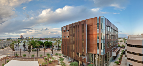 Exterior view of ASU's Edson College of Nursing and Health Innovation Health North Building against the Downtown Phoenix skyline.