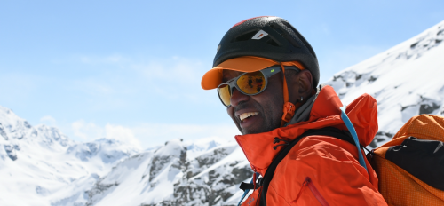 Portrait of ASU alumnus Robert Moody smiling in ski gear in front of a snowy mountain summit.