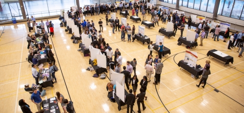 Engineering students and faculty gather for a capstone projects showcase event