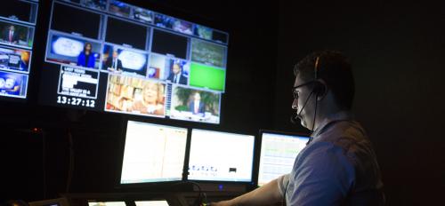 man in broadcast news control room