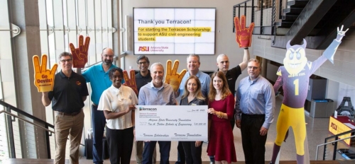 Members of the Terracon Foundation, the ASU Foundation and Professor Ram Pendyala standing at the top of a staircase holding a large check. A sign in the background reads "Thank you Terracon!" 