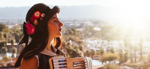 Tatiana Crespo poses outdoors in Phoenix with her accordion