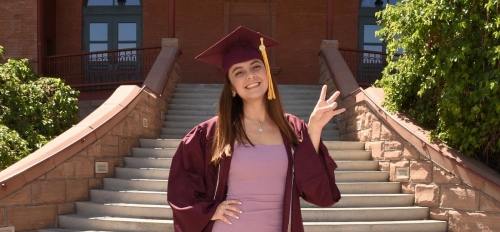 Outstanding Graduate Valeria Reyes standing in front of Old Main at ASU