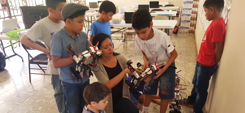 Victoria Serrano shows robots to young students