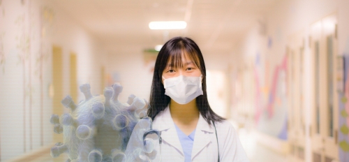 nurse standing with arms folded, virus in foreground