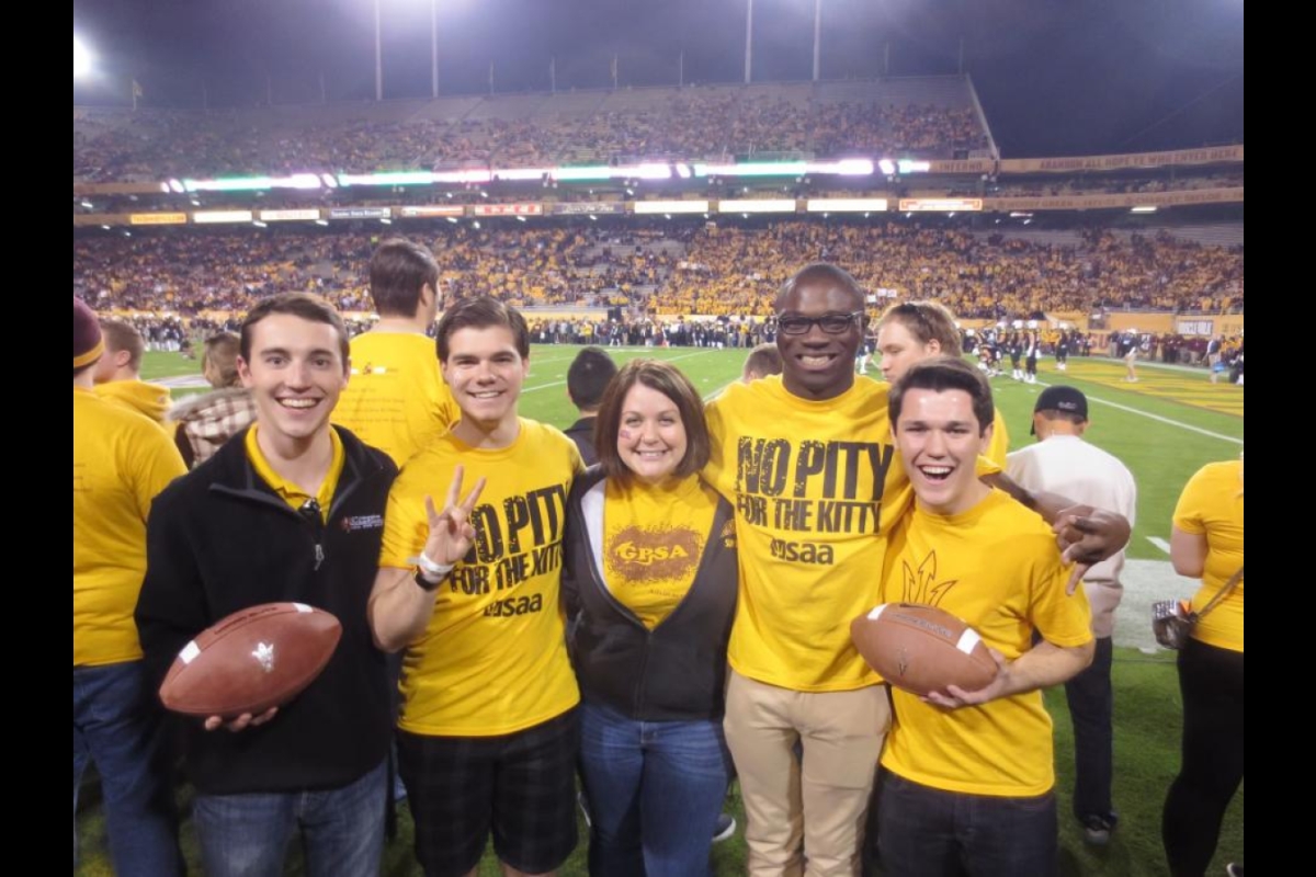 Frank Smith poses with friends at an ASU football game
