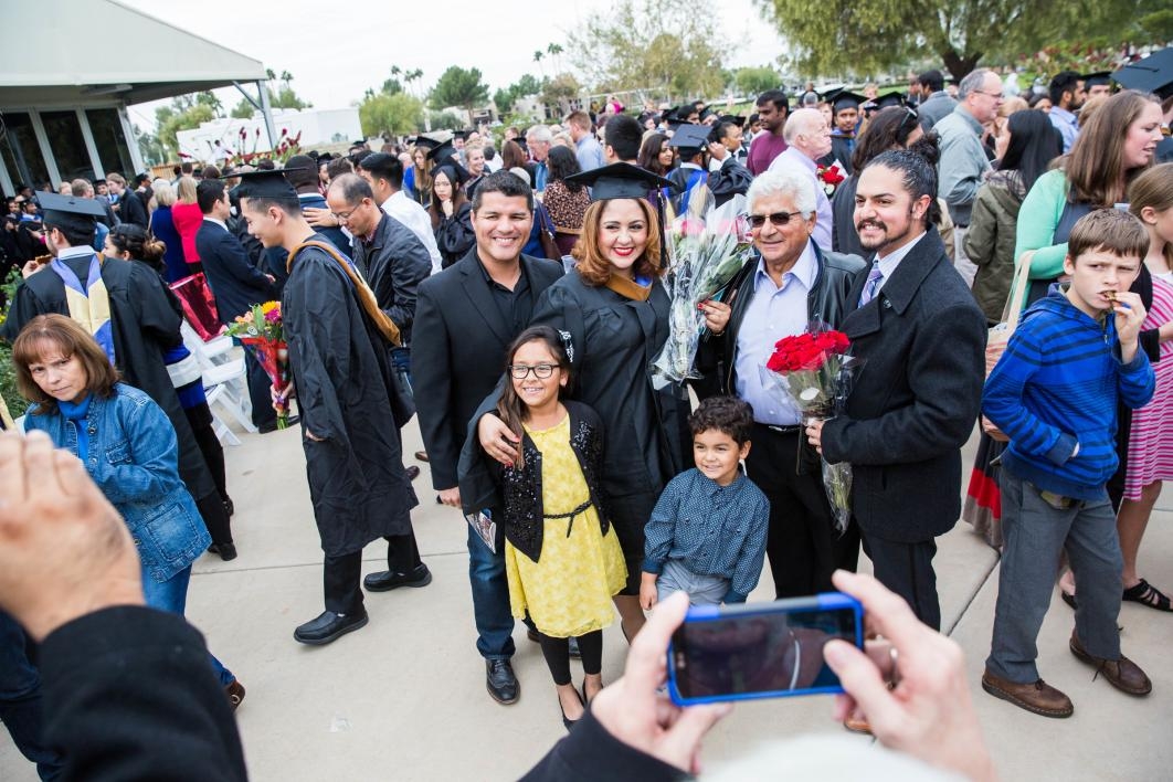 A family poses for a photo after graduation.