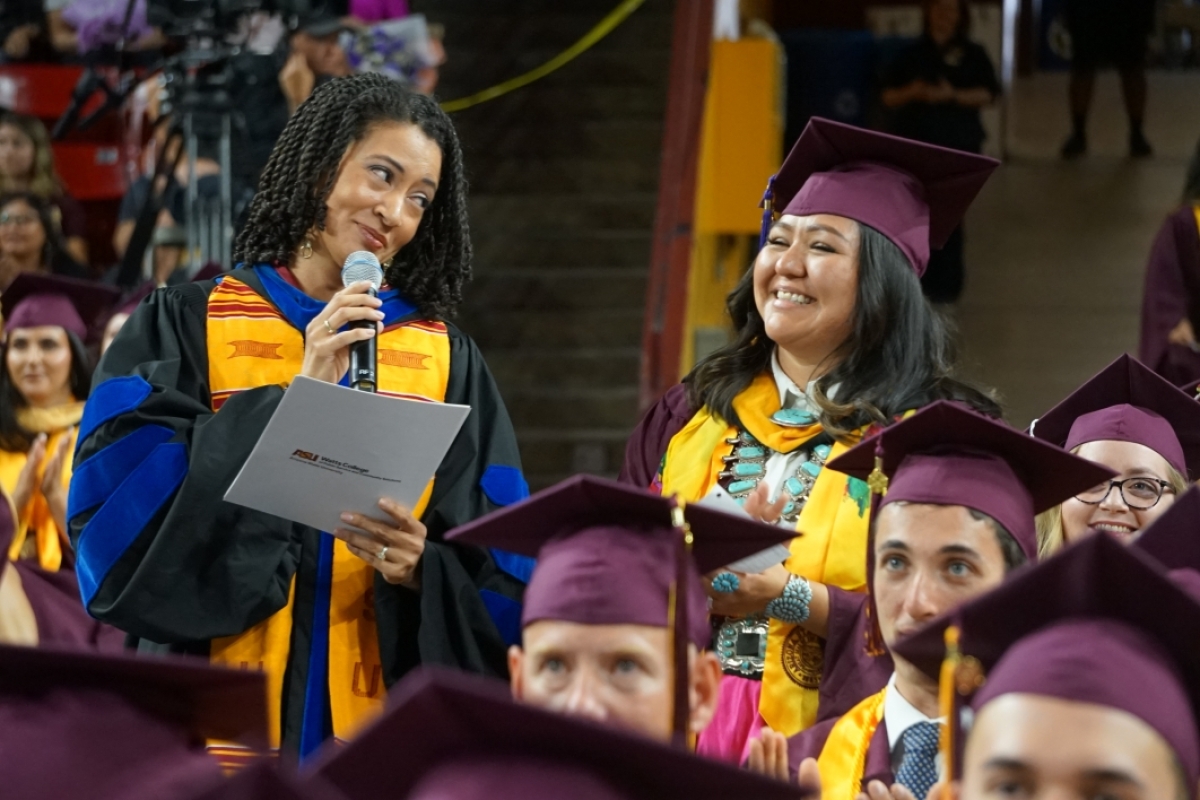 Chandra Crudup and Cassie Harvey shown at the convocation smiling with a microphone.