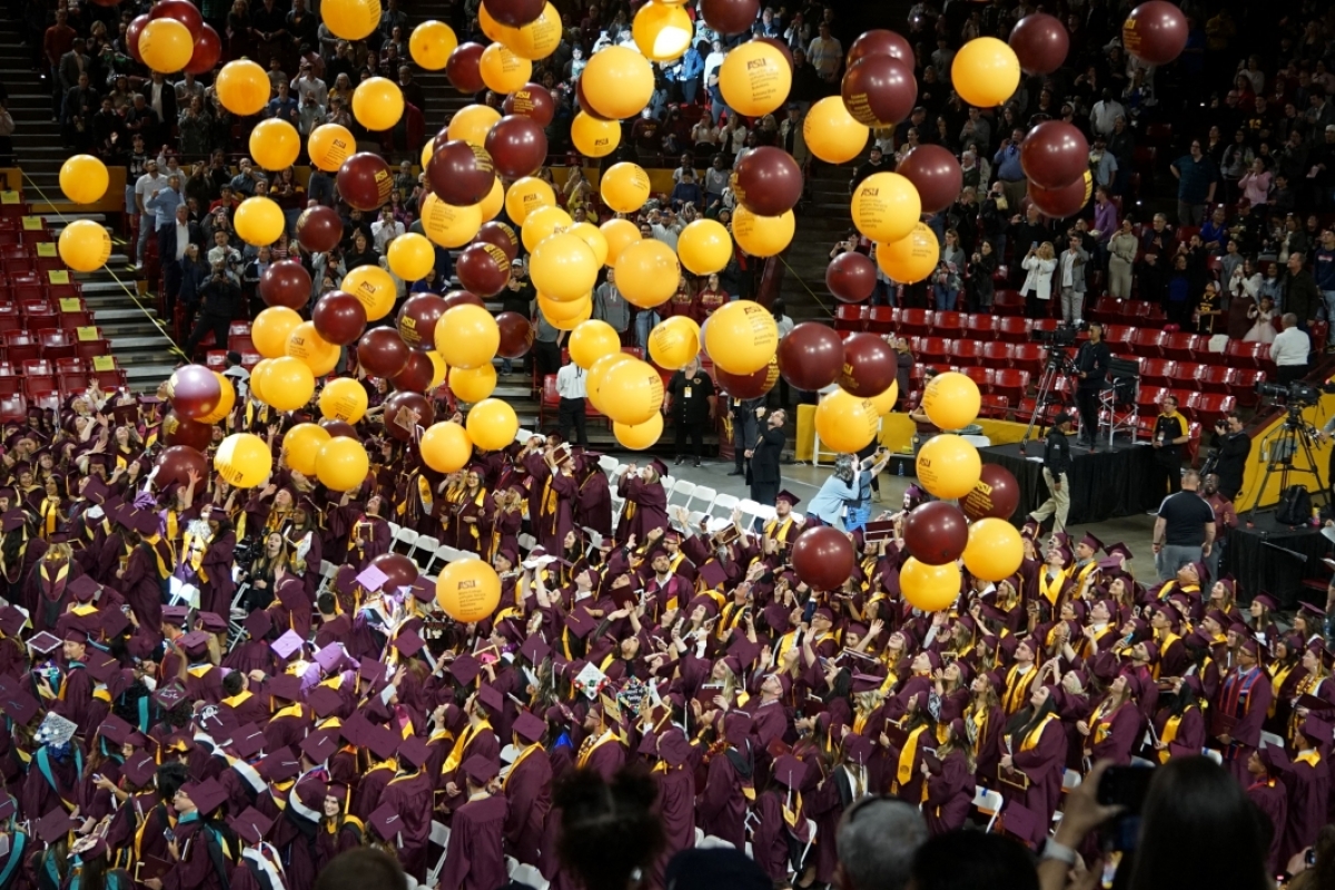 Balloons fall from rafters of Desert Financial Arena at Watts College of Public Service and Community Solutions' fall 2023 convocation.