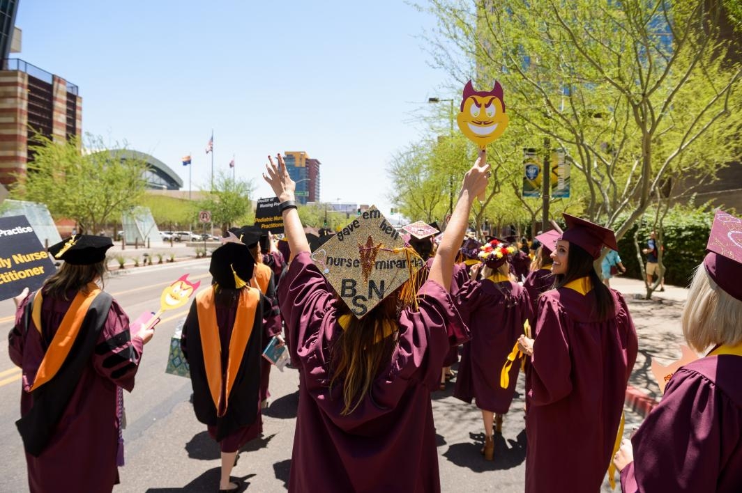 graduates walking down downtown Phoenix street