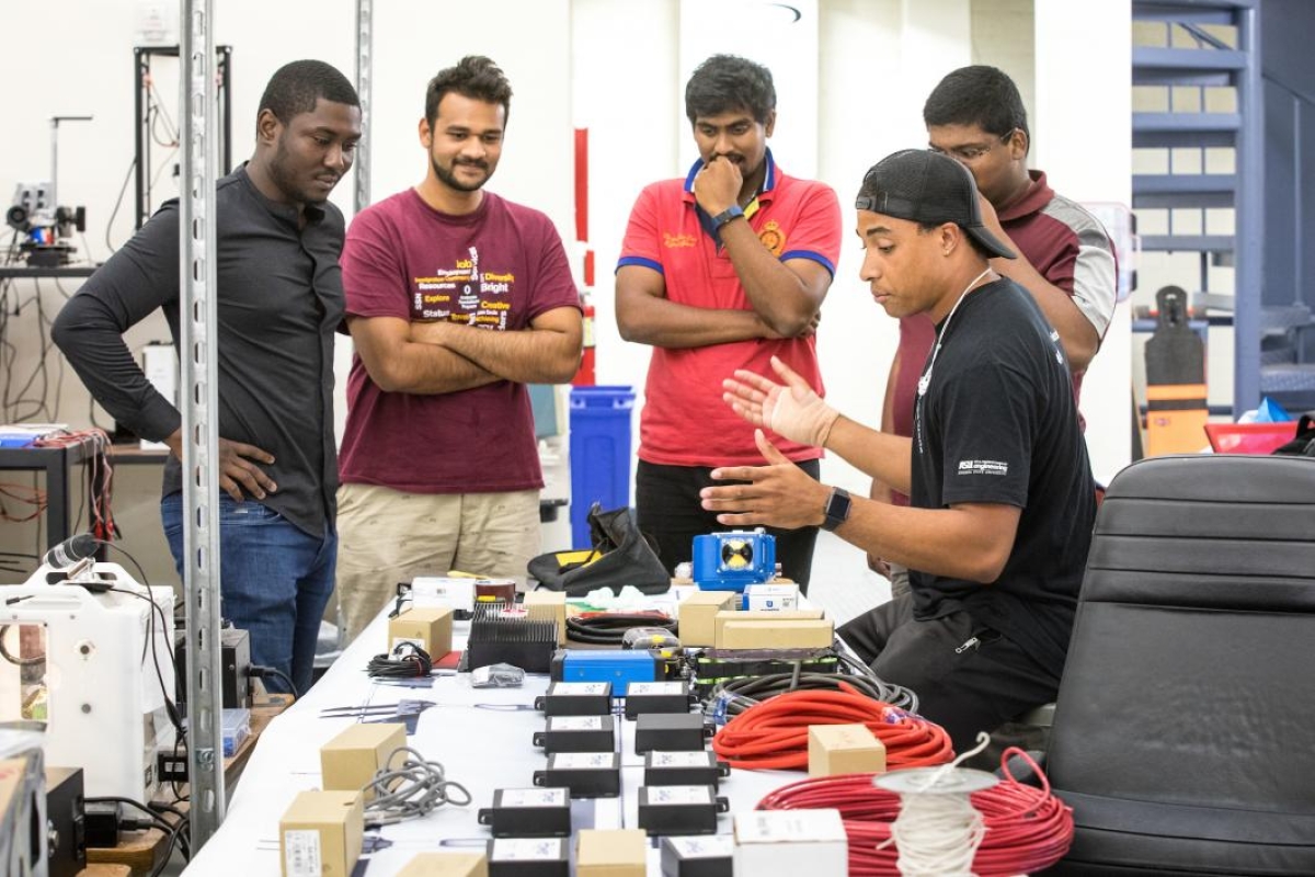 The AZLoop team looks over electrical components