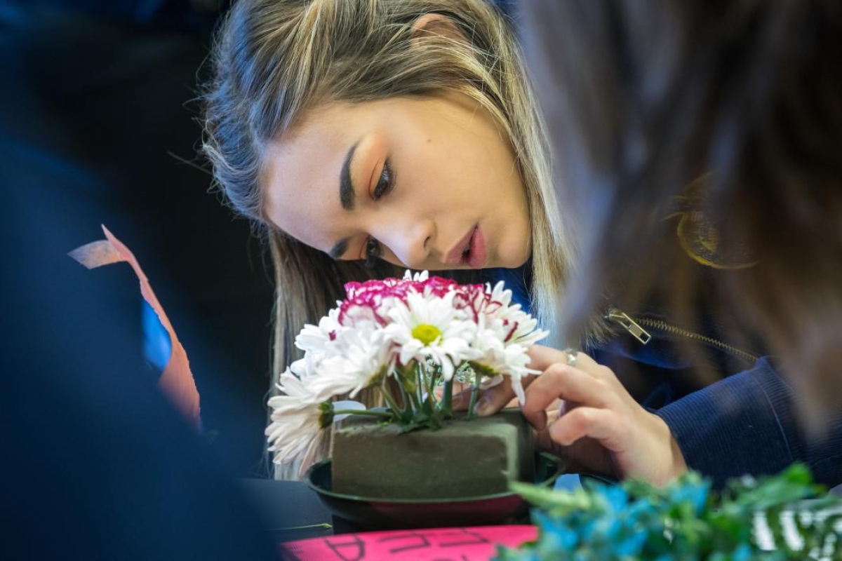 Alyse Sanchez arranges flowers at FFA Conference