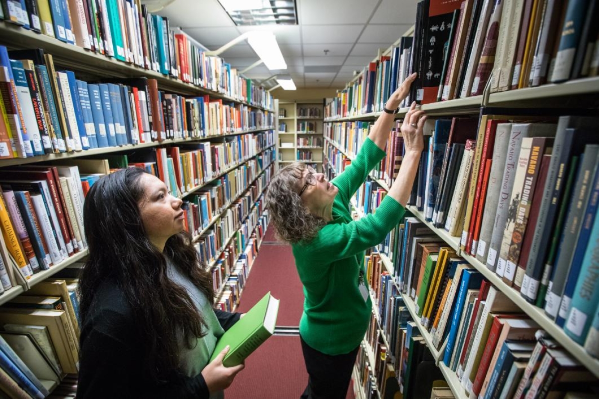 ASU student Modesta Molina and Heard Museum librarian Betty Murphy working in the stacks