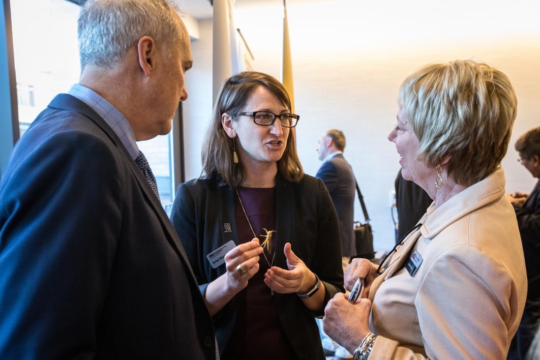A locust researcher talks to people at a reception