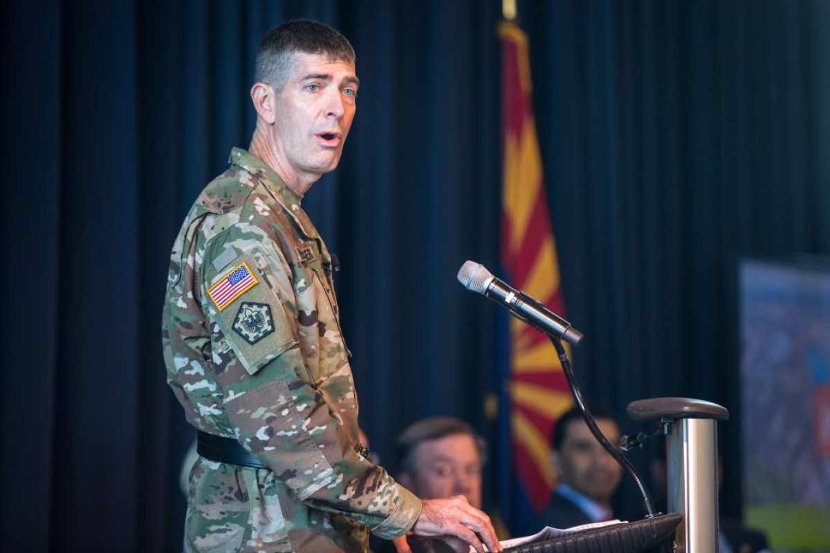 An Army engineer speaks at a lectern
