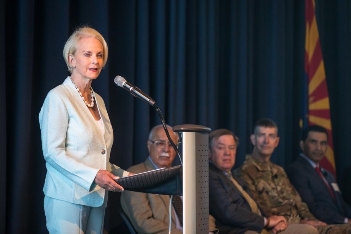 Cindy McCain speaks at a lectern