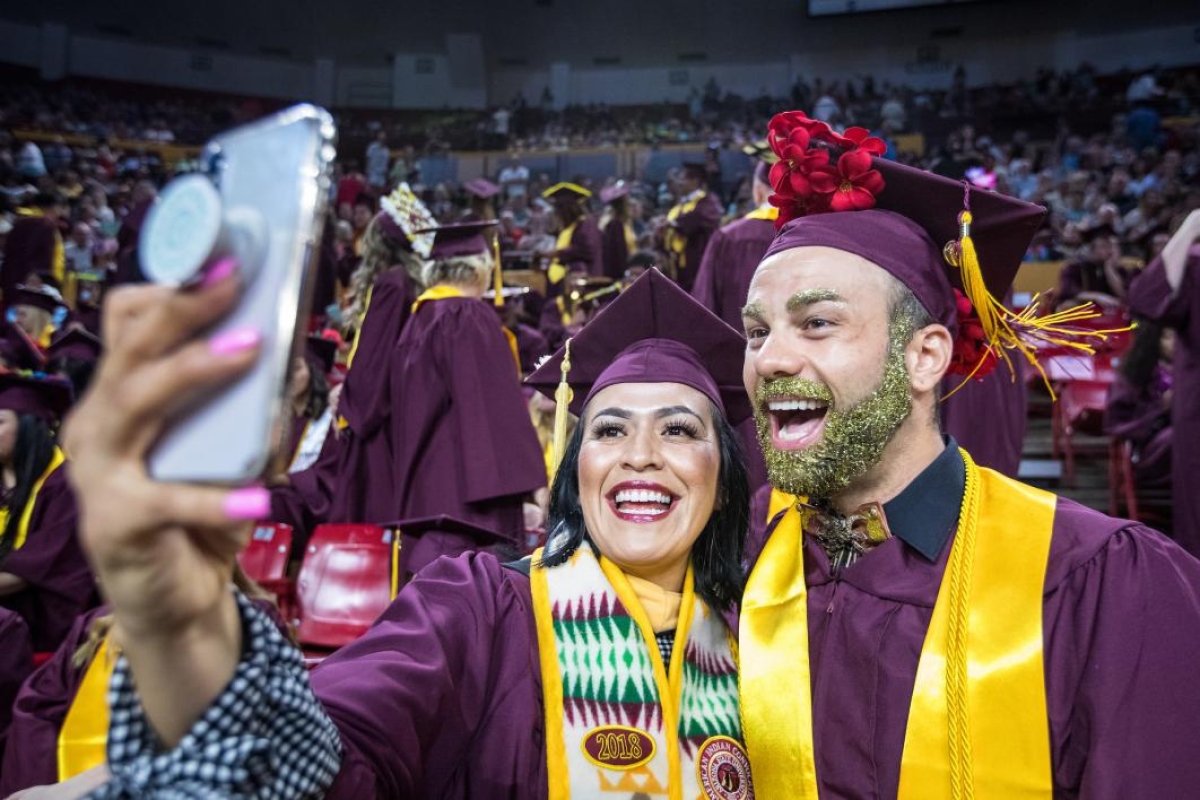 two grads taking a selfie