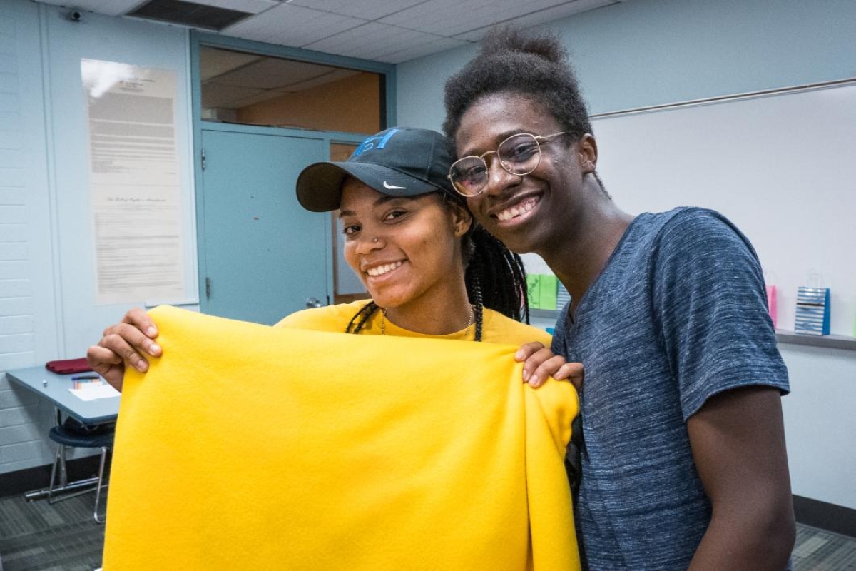 ASU Bridging Success Early Start students show off the blanket they made for Helen's Hope Chest