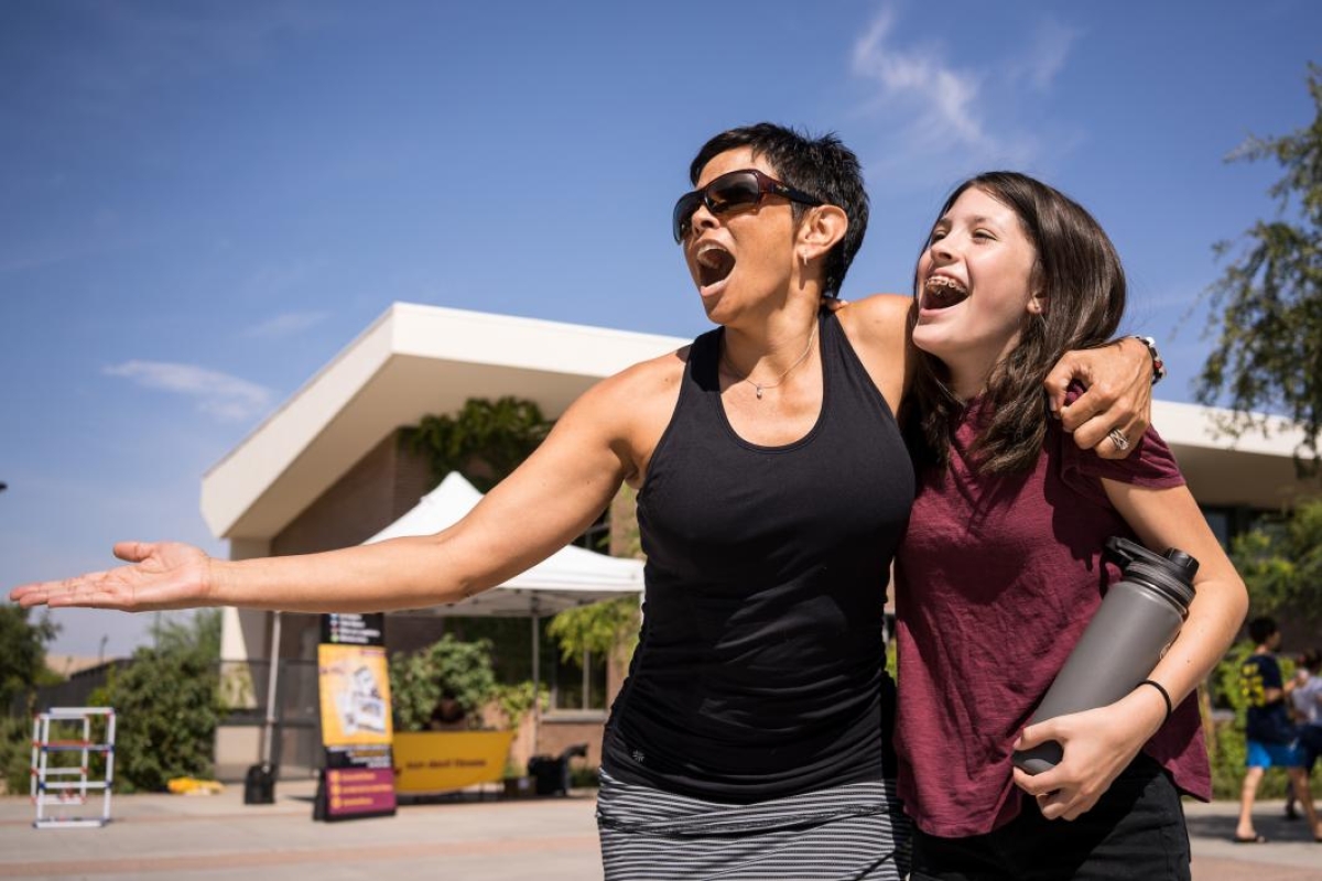 A mother and daughter sing silly songs during move-in at West campus