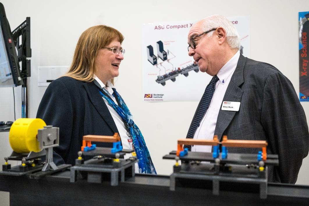 Petra Fromme (left) and Stephen Munk stand in front of a model of the x-ray laser