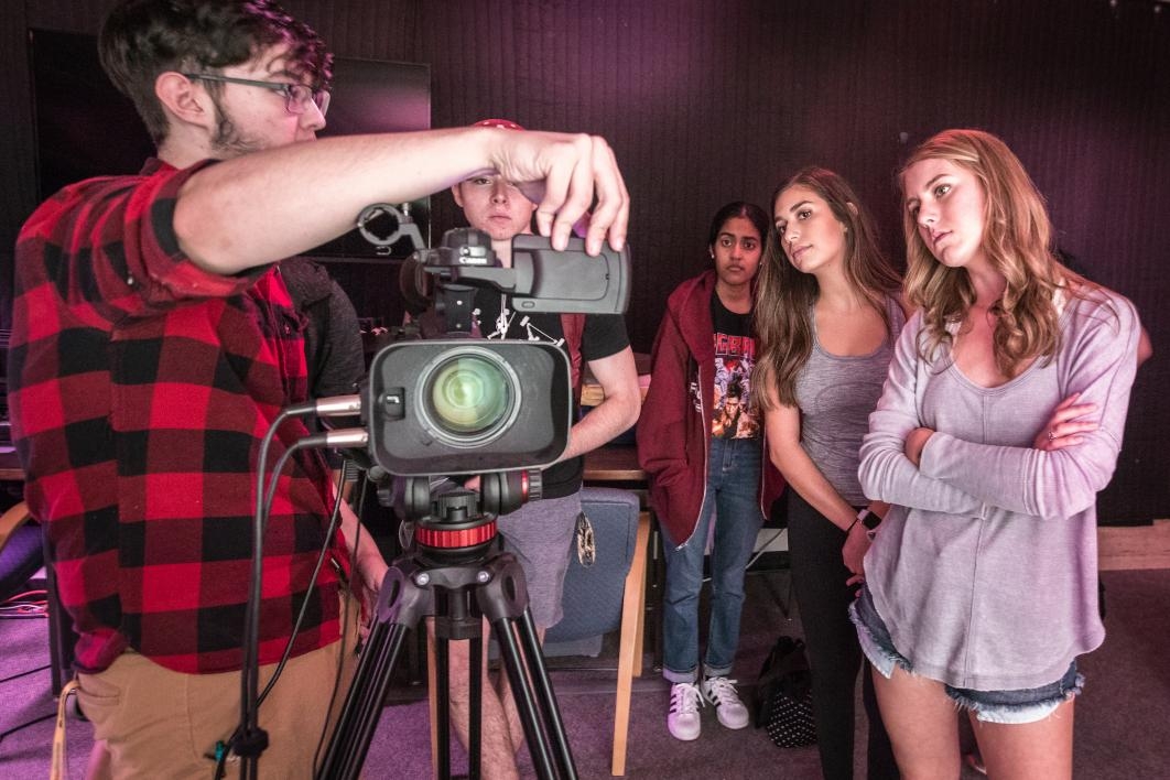 Matt Roman, a student worker at the ASU Library mkrspace, gives a short lesson on the video camera and studio lights to a class of ASU students