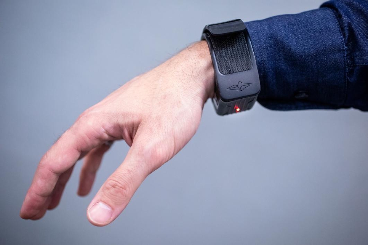 A hand displays a fitness monitor