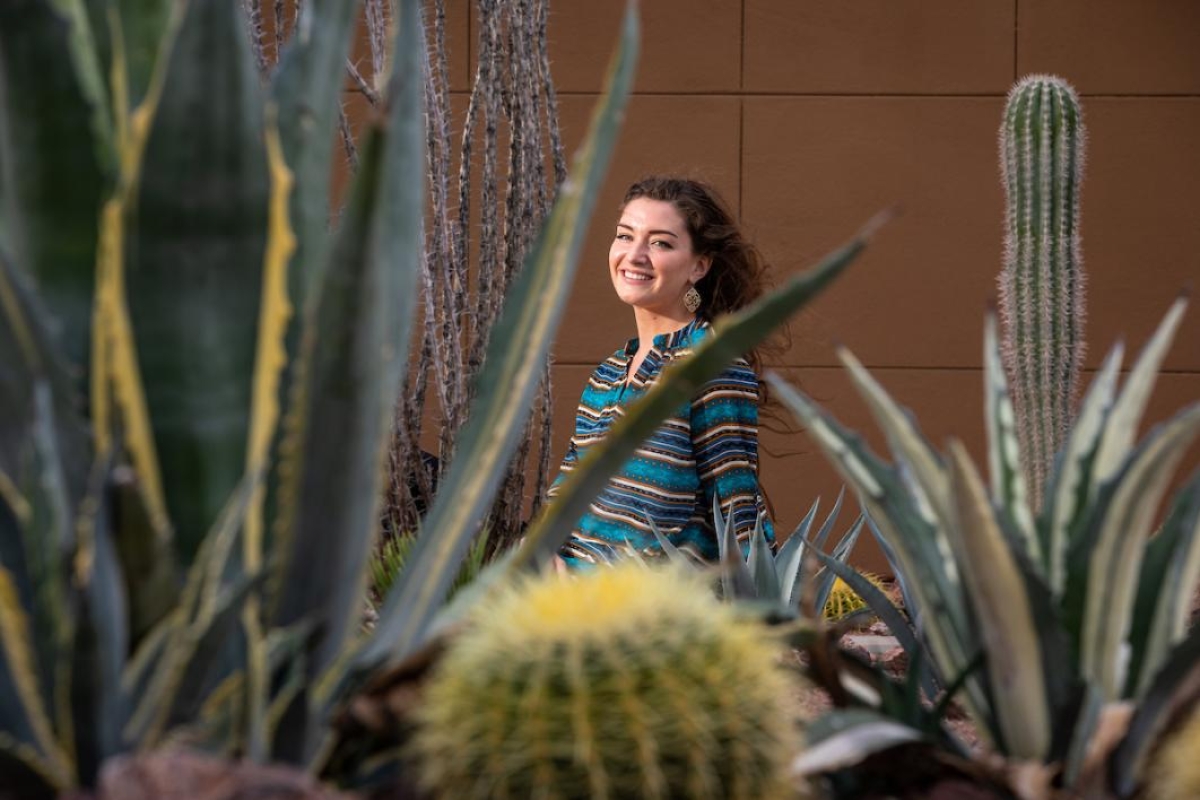Woman in between cactus plants