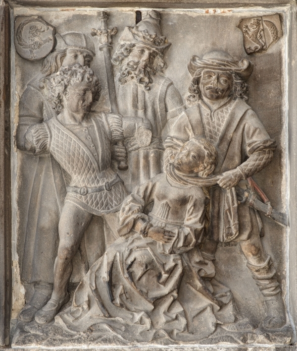 stone relief scuplture depciting the torture of a saint