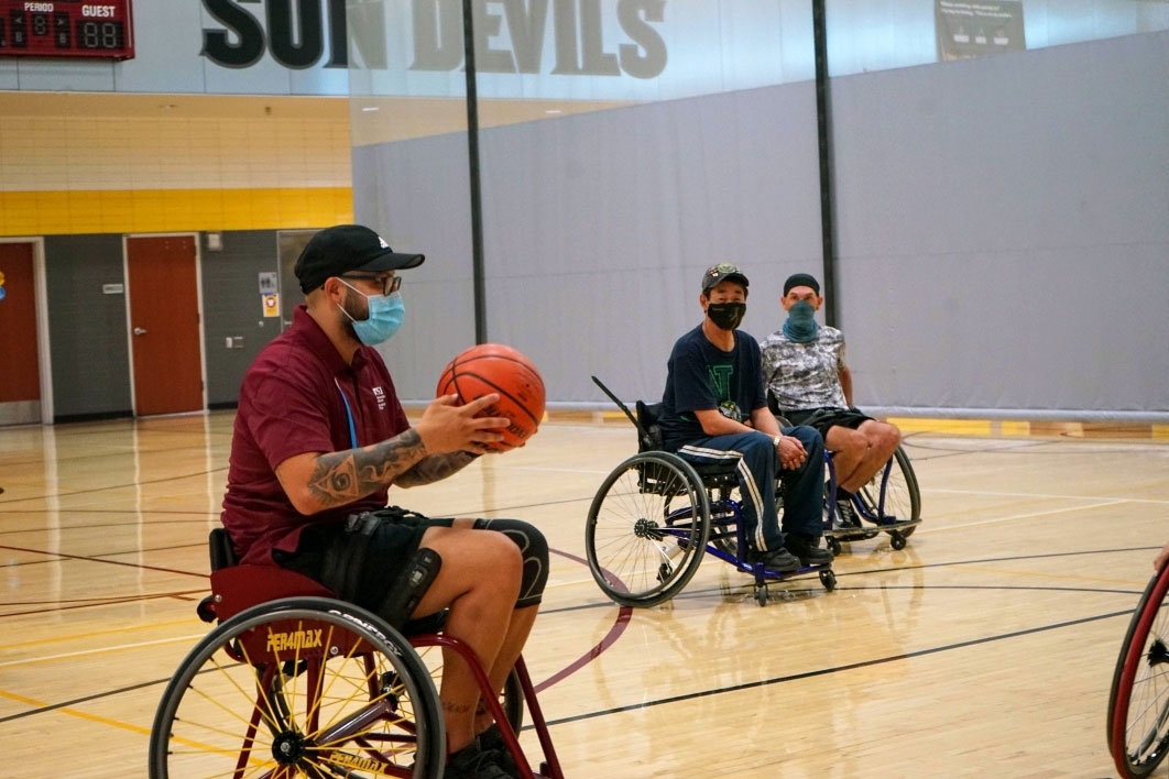player using wheelchair holding a basketball