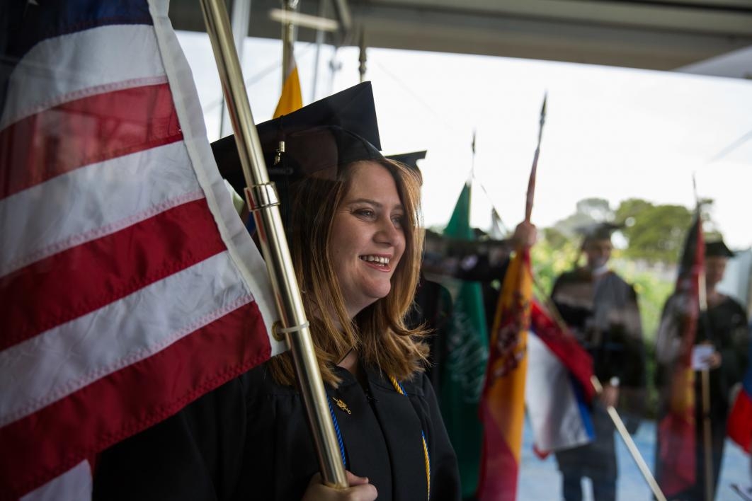 A student holds a U.S. flag