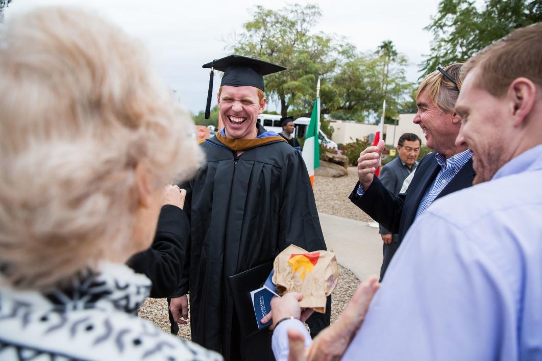 A student laughs at graduation.