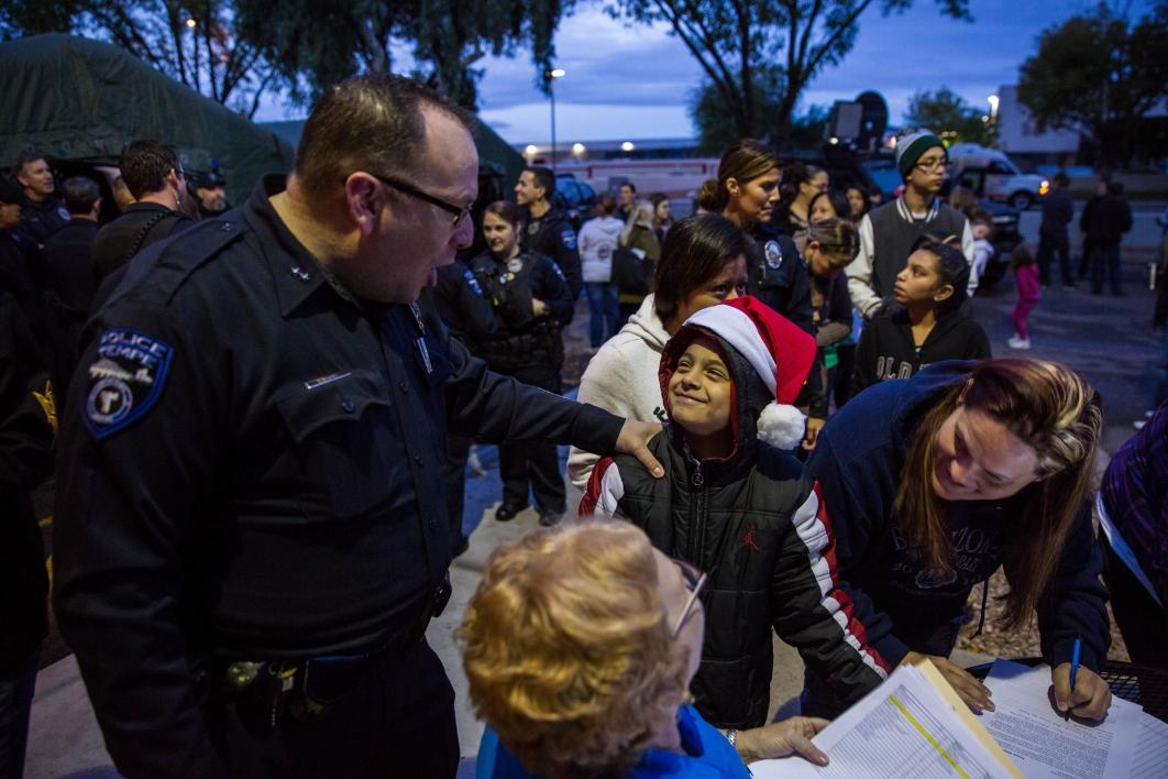 child signing up for shop with a cop event