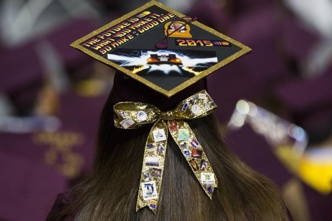 A graduation cap is covered with Back to the future references and a hair bow with the student's personal likes