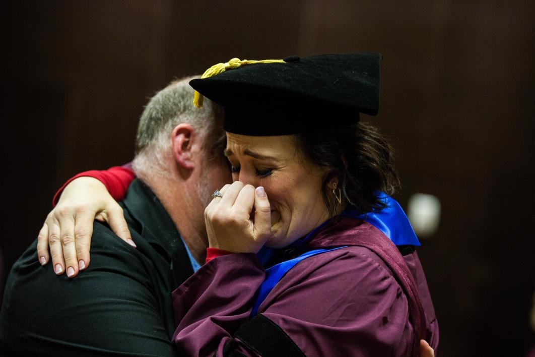ASU law student crying as she hugs her husband