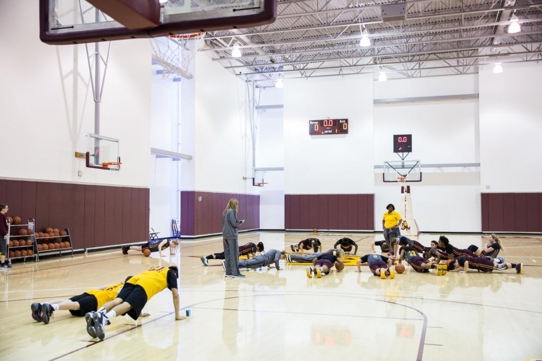 Basketball players doing push-ups.