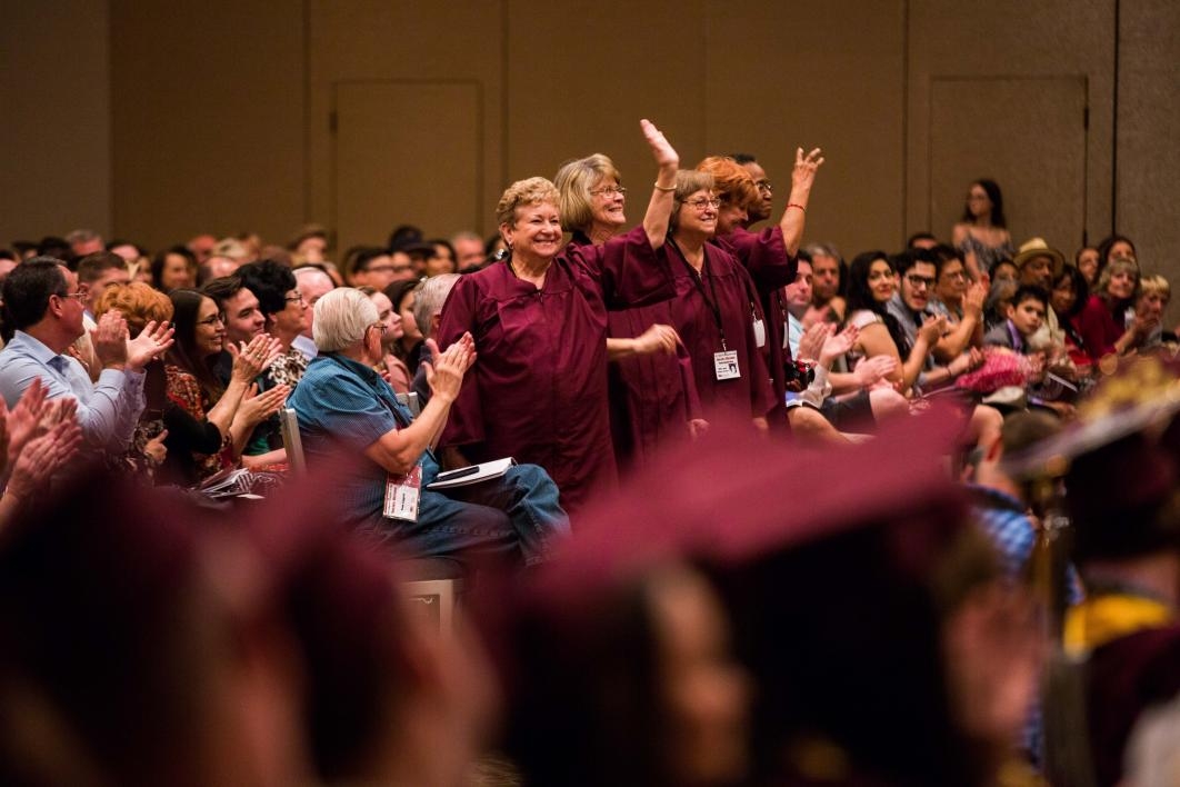 golden grads waving to graduates