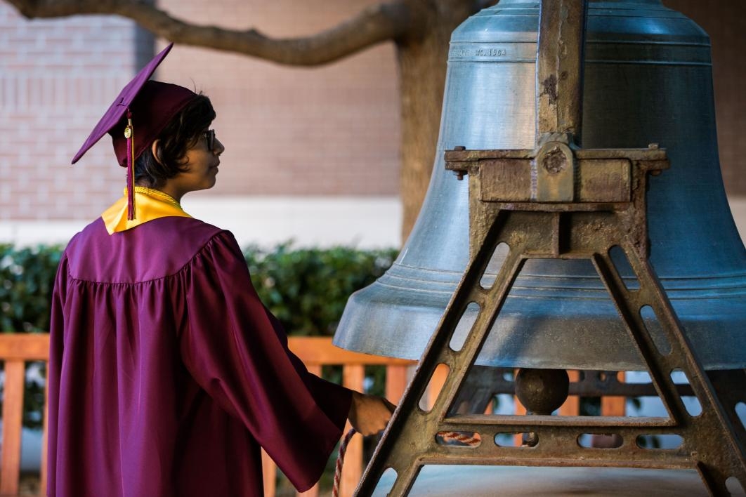 graduate ringing large bell