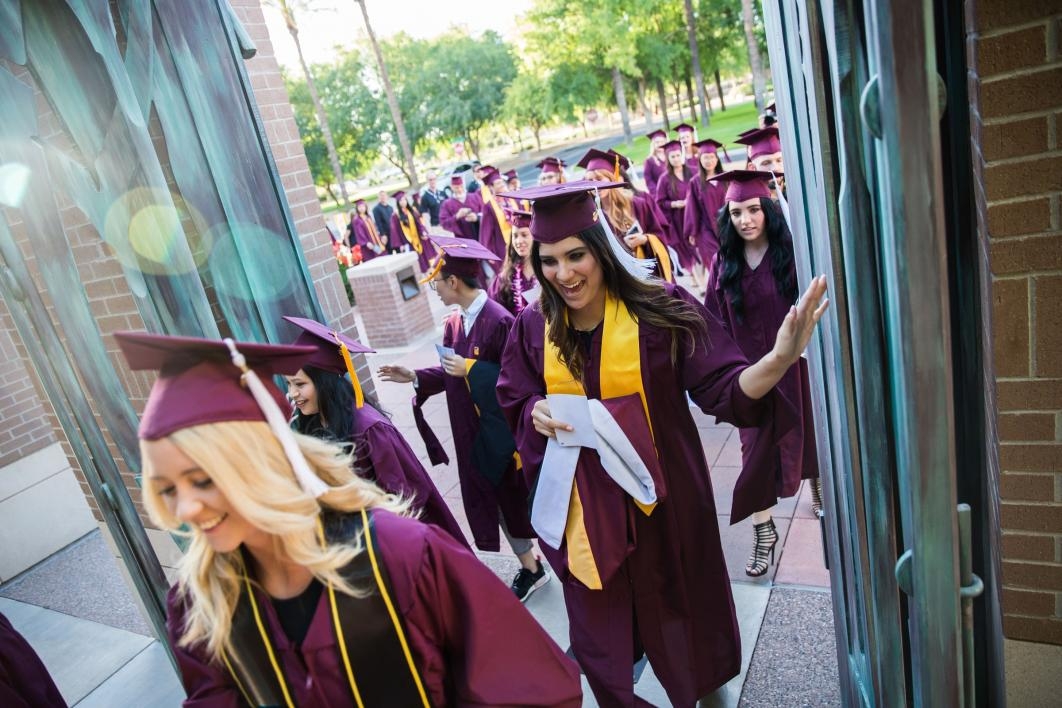 Grads walking through Paley Gates at West campus