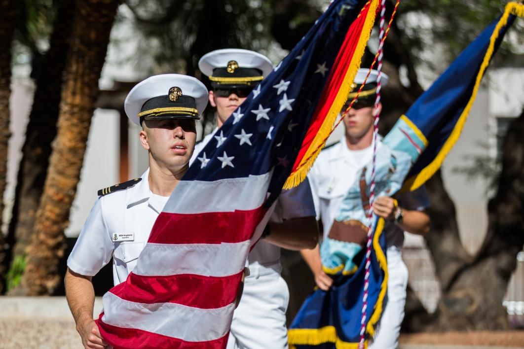 Naval cadets entering ceremony with flags