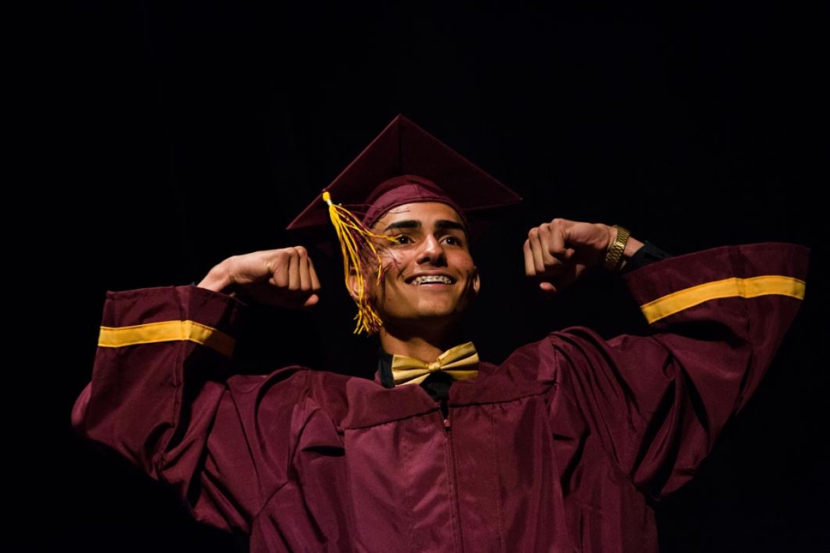 A student poses on stage during the ASU Prep-Phoenix commencement.